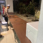 Anggota jawatankuasa surau membuat persiapan dengan menyusun meja untuk majlis 'Open House' 2024.